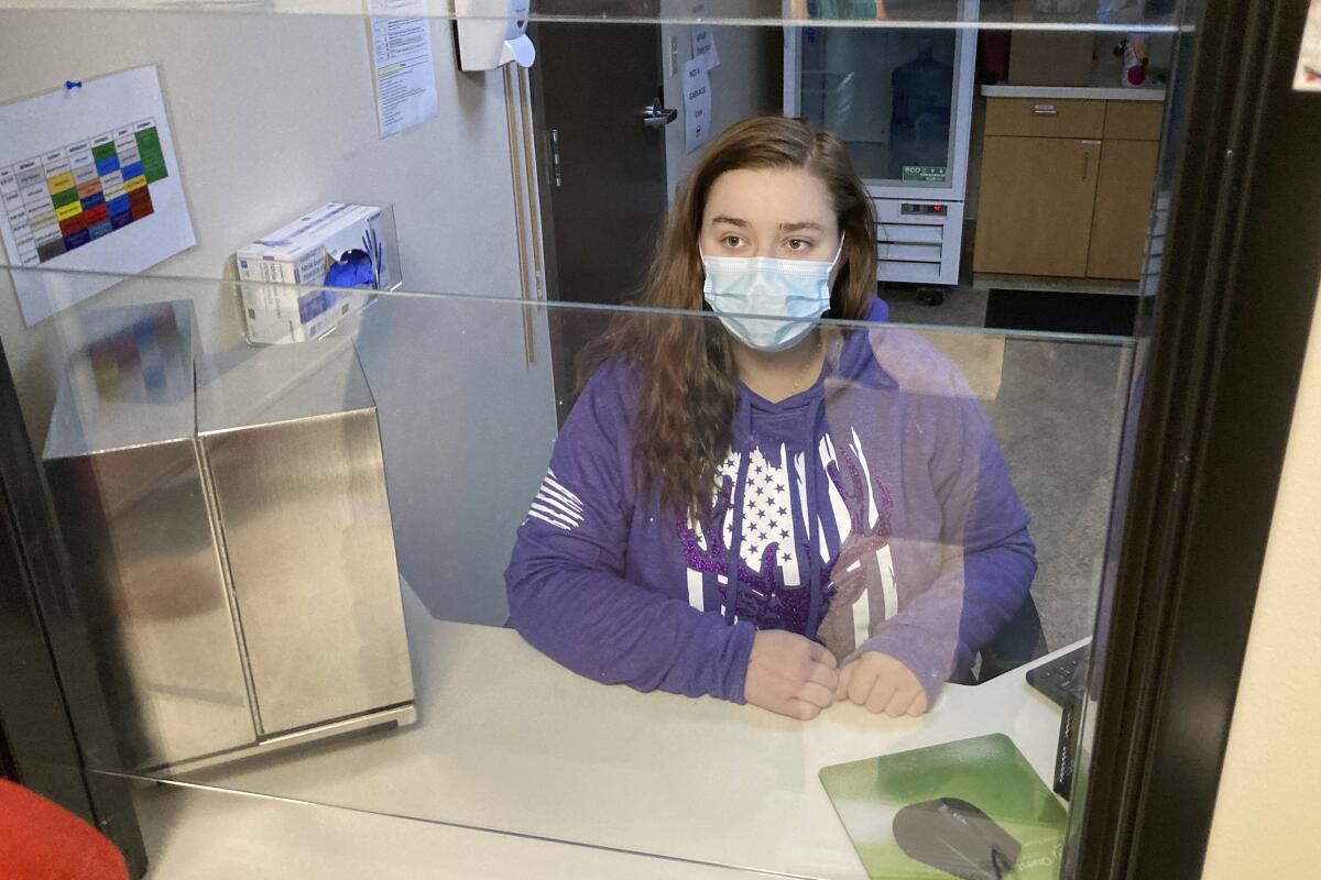 A nurse sits at her work station.
