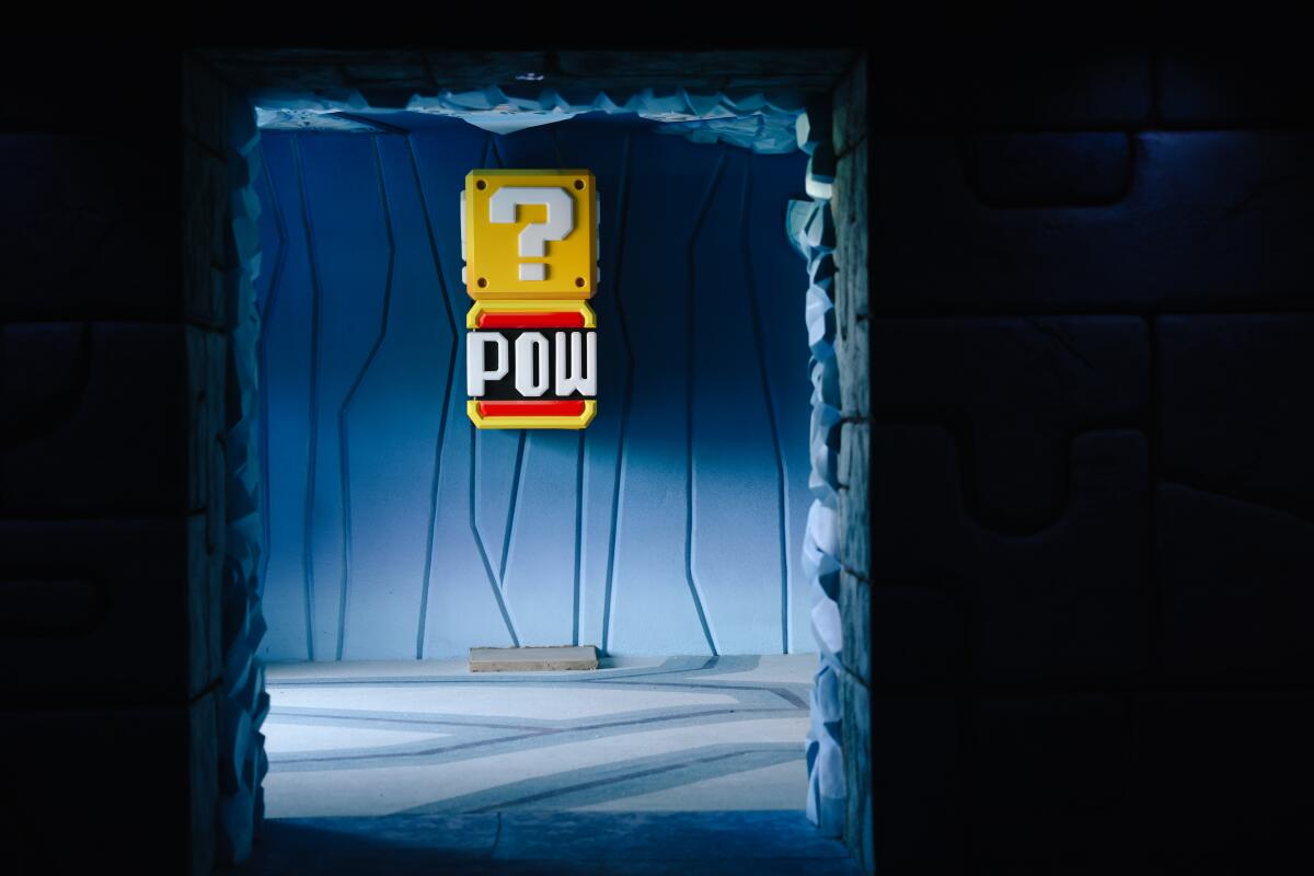 A wall opening reveals a sign containing the word "pow" and a question mark.