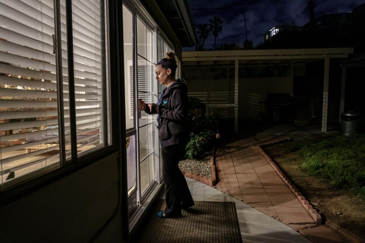 Nurse Erin Jenkins arrives at home after her shift at UCSD Health in San Diego.