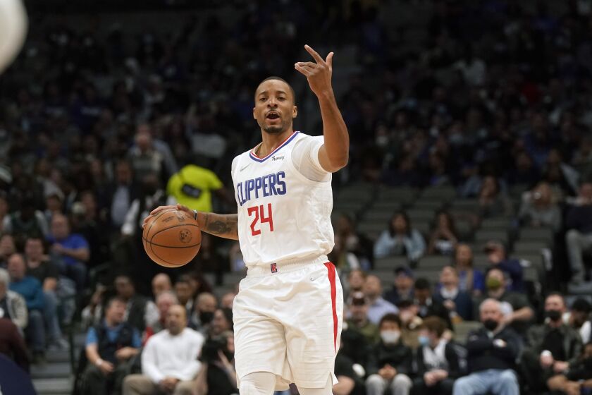 LA Clippers forward Norman Powell (24) calls a play during the first quarter of an NBA basketball game against the Dallas Mavericks in Dallas, Thursday, Feb. 10, 2022. (AP Photo/LM Otero)