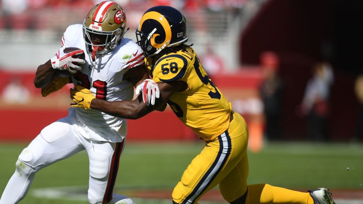 Rams linebacker Cory Littleton tackles San Francisco 49ers running back Raheem Mostert in Sunday's game.