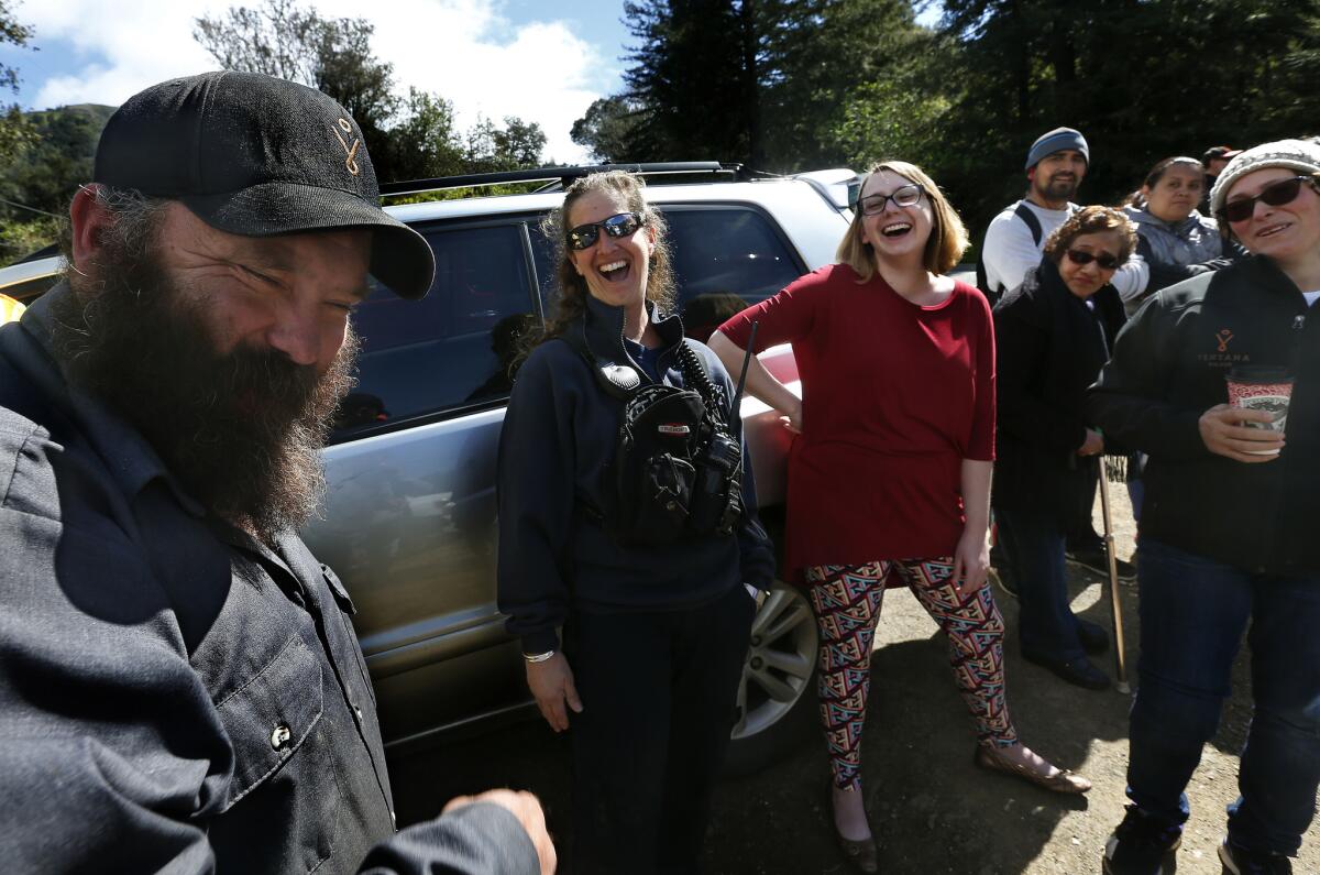 Jeannie Alexander, second from left, a medical captain with the Big Sur Volunteer Fire Brigade, enjoys a moment with other residents after she playfully touched the beard of Josh Case, left, an employee at the Ventana Inn and Spa. (Mel Melcon / Los Angeles Times)