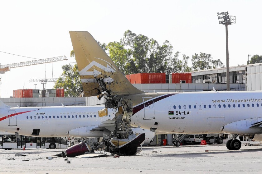 Planes were damaged as one group of militia fighters captured the airport in Tripoli, Libya's capital, from another group.