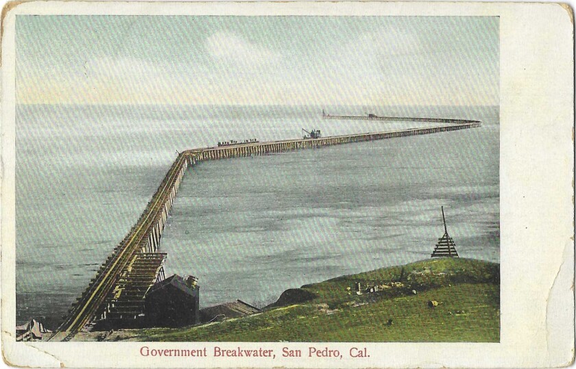 Postcard shows a breakwater snaking from the shoreline out to sea.
