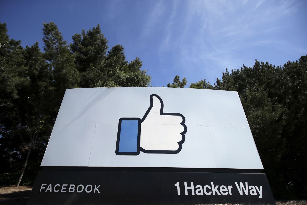 FILE - In this April 14, 2020 file photo, the thumbs up Like logo is shown on a sign at Facebook headquarters in Menlo Park, Calif. A Moscow court has ruled to enforce the collection of fines from Facebook for breaching Russian laws on illegal content, officials said Thursday Oct. 7, 2021. (AP Photo/Jeff Chiu, File)