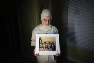 Maryam Kamalmaz hold a photo of her father with some of his 14 grandchildren in Grand Prairie, Texas, Jan. 17, 2024. By any standard, the past 18 months have been remarkable for getting wrongfully detained Americans home. But not so for Kamalmaz, who has had no trace of her father, Majd Kamalmaz, since the psychologist from Texas was stopped at a checkpoint in Syria in 2017 after traveling there to visit an elderly family member. He remains one of several Americans missing in Syria, including journalist Austin Tice, despite a 2020 visit by Carstens to try to negotiate their release. (AP Photo/Julio Cortez)
