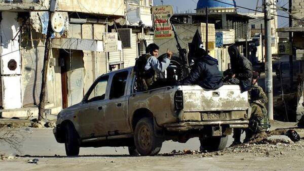 Islamic State fighters drive through Raqqah, capital of their self-declared caliphate in Syria. (Associated Press)