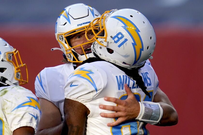 Los Angeles Chargers wide receiver Mike Williams (81) celebrates his touchdown catch with quarterback Justin Herbert during the second half of an NFL football game, Sunday, Nov. 1, 2020, in Denver. (AP Photo/David Zalubowski)