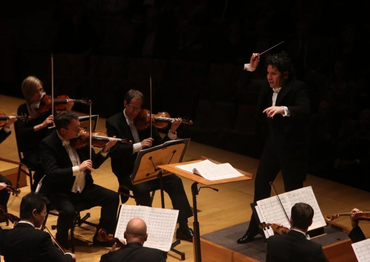 Gustavo Dudamel, shown here conducting the L.A. Philharmonic in John Corigliano's Symphony No. 1 on Thursday, halted the Disney Hall concert until the altercation was over at Friday's concert.