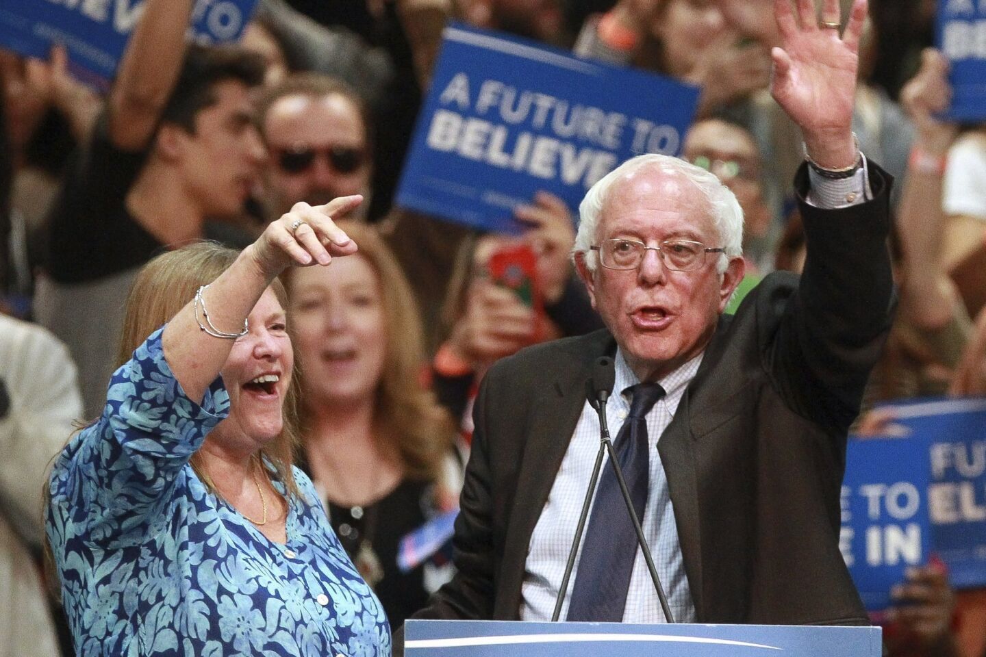 Democratic presidential candidate Bernie Sanders and his wife Jane Sanders wave at the conclusion of Sander's speech.