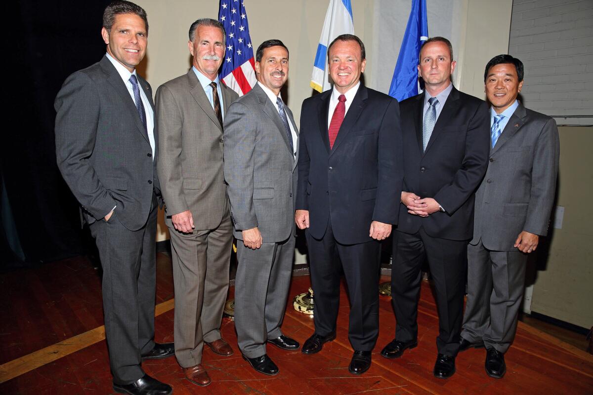 Six of the seven candidates running for Los Angeles County sheriff pose after a debate at the Jewish Community Center in Los Angeles. From left are James Hellmold, Bob Olmsted, Todd Rogers, Jim McDonnell, Lou Vince and Paul Tanaka.