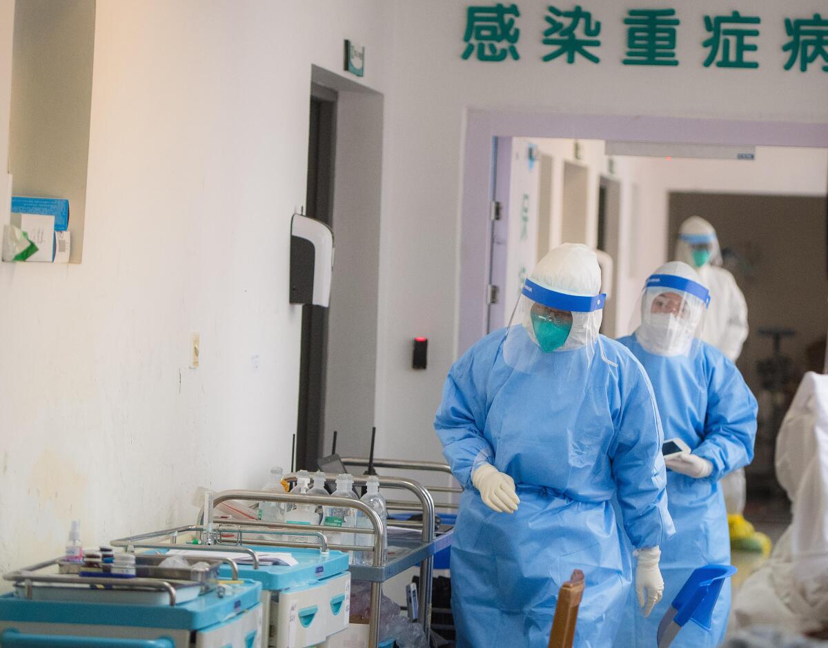 Medical personnel wearing protective suits work in the infectious diseases department at Wuhan Union Hospital.