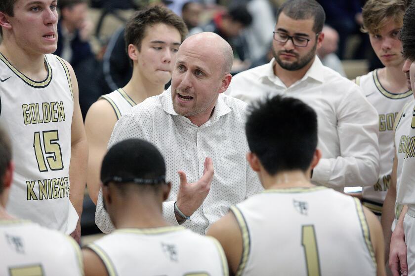 St. Francis' head coach Todd Wolfson, during a timeout against La Canada, talks with his team in a nonleague boys' basketball game at St. Francis High School on Tuesday, December 10, 2019.