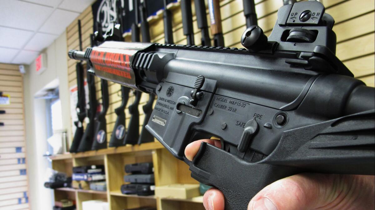 An employee of North Raleigh Guns demonstrates how a bump stock works at the Raleigh, N.C. shop on Feb. 1, 2013.