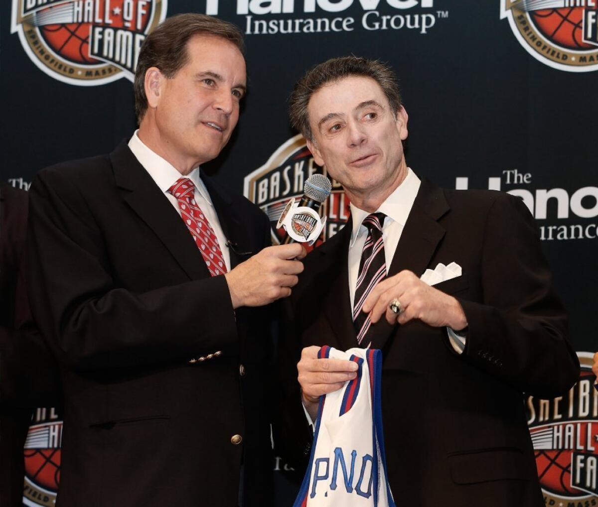 CBS broadcaster Jim Nance talks to Louisville Coach Rick Pitino during the Naismith Memorial Basketball Hall of Fame announcement ceremony.
