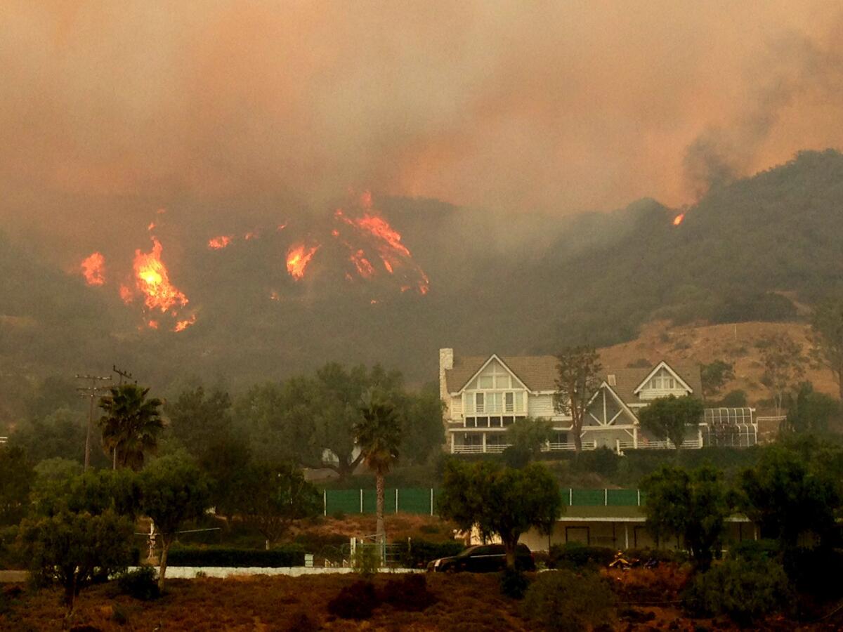 Fire comes close to homes in the hills above Hidden Valley in Thousand Oaks.