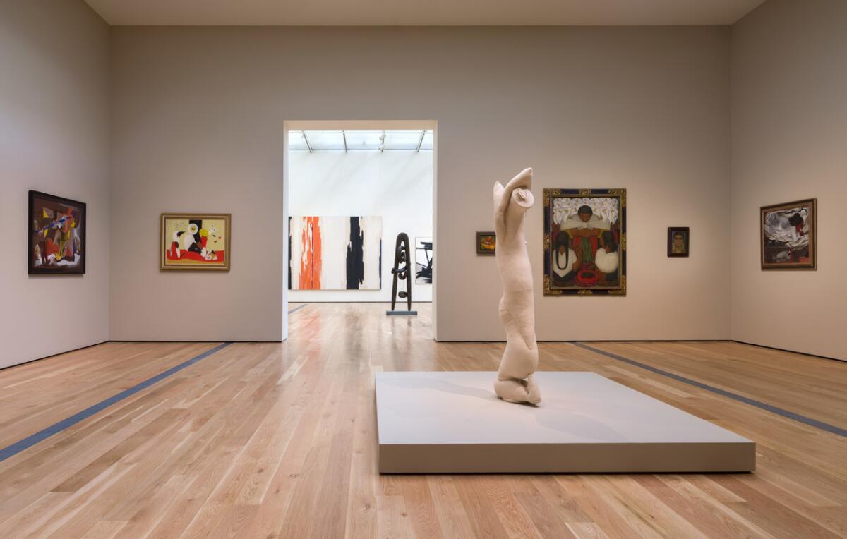 A gallery full of art at a museum.
