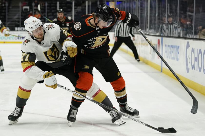 Vegas Golden Knights defenseman Shea Theodore (27) takes control of the puck from Anaheim Ducks center Troy Terry (61) during the second period of an NHL hockey game Friday, April 16, 2021, in Anaheim, Calif. (AP Photo/Ashley Landis)