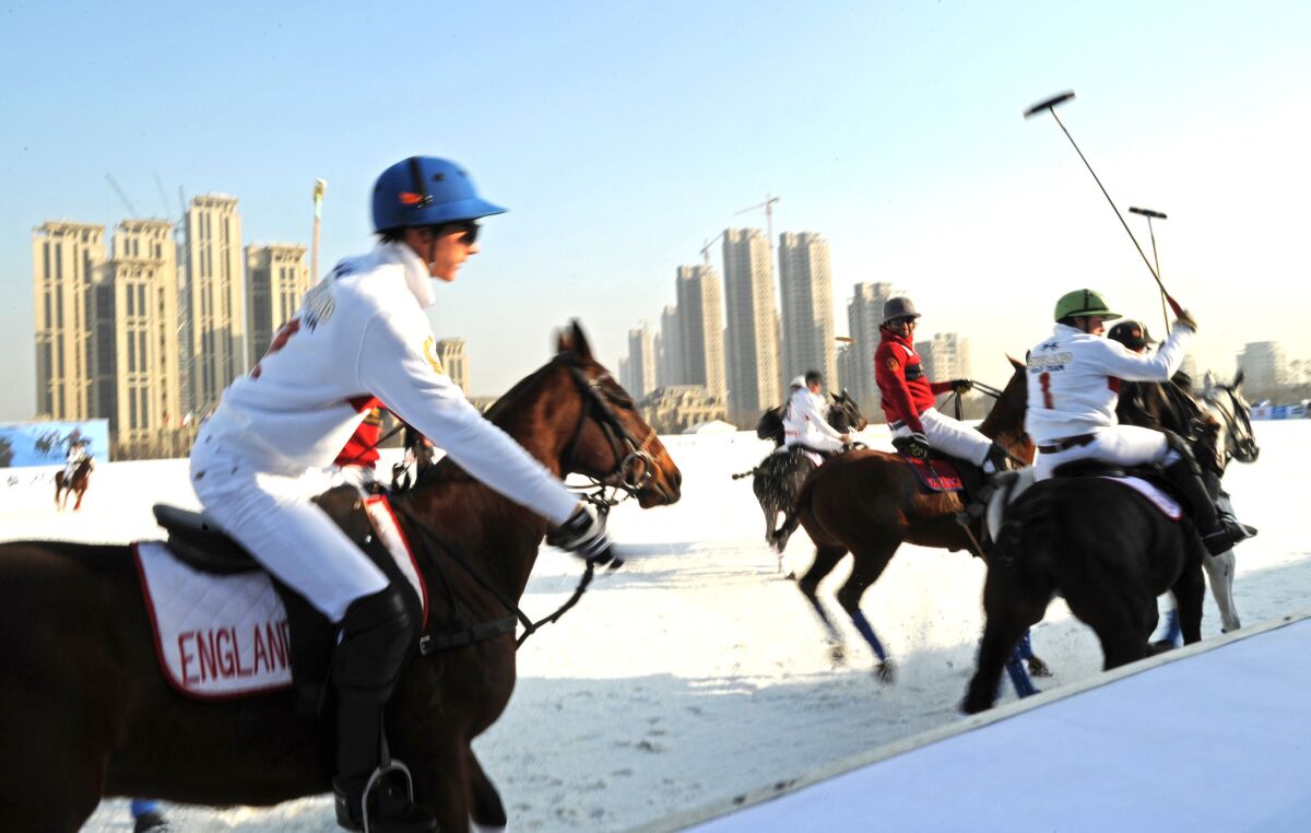 Team England faces off against the Hong Kong China team at the Snow Polo World Cup in Tianjin, China.