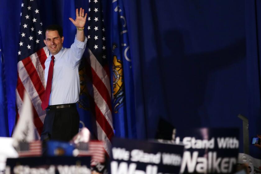 Wisconsin Republican Gov. Scott Walker waves at his victory party Tuesday, June 5, 2012, in Waukesha, Wis. Walker defeated Democratic challenger Tom Barrett in a special recall election. (AP Photo/Morry Gash)