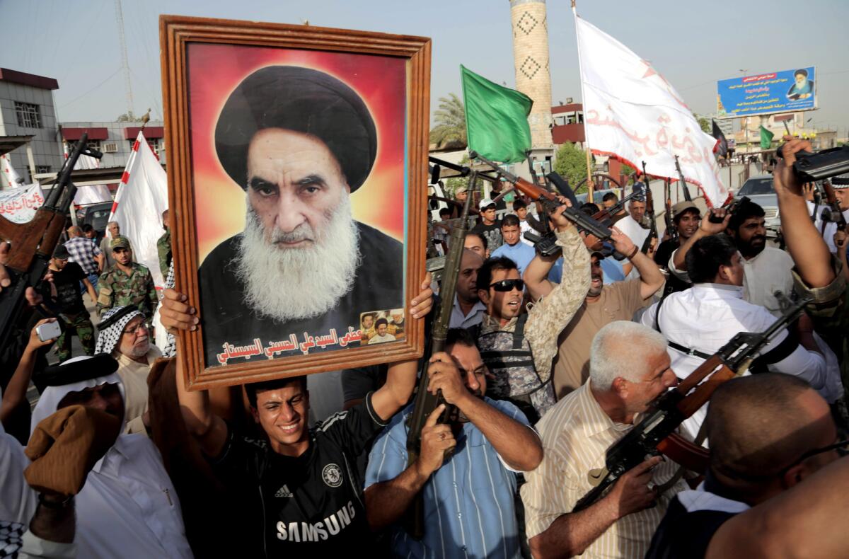 Iraqi tribal fighters hold up a portrait of Shiite Muslim leader Ayatollah Ali Sistani and chant slogans against Sunni Muslim insurgents of the Islamic State of Iraq and Syria in Baghdad's Sadr City on Wednesday.
