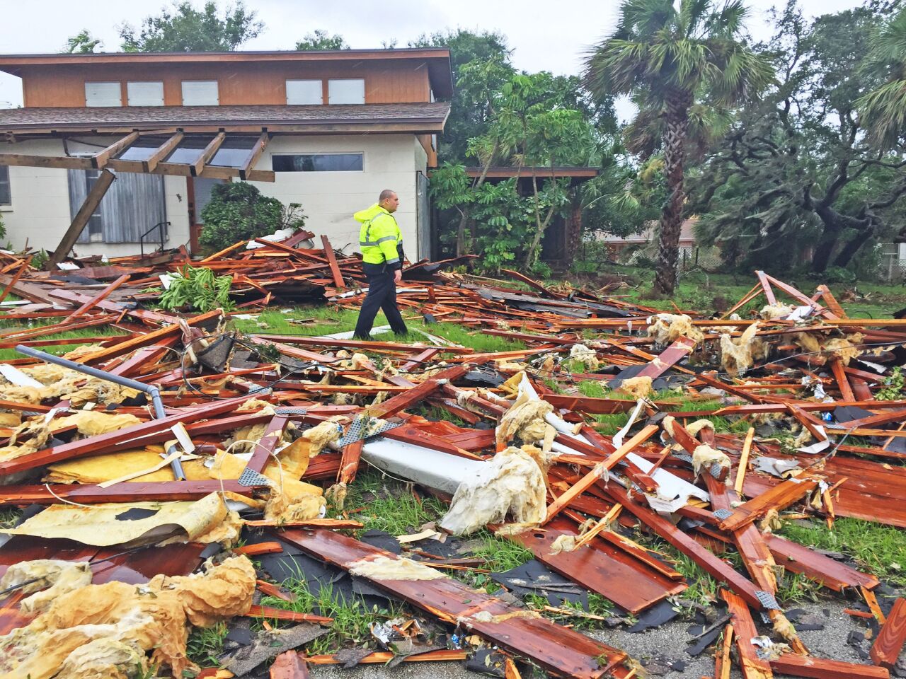Dustin Terkoski, Palm Bay Police officer surveys the scene after a possible tornado touched down at Palm Pam Bay Estates.