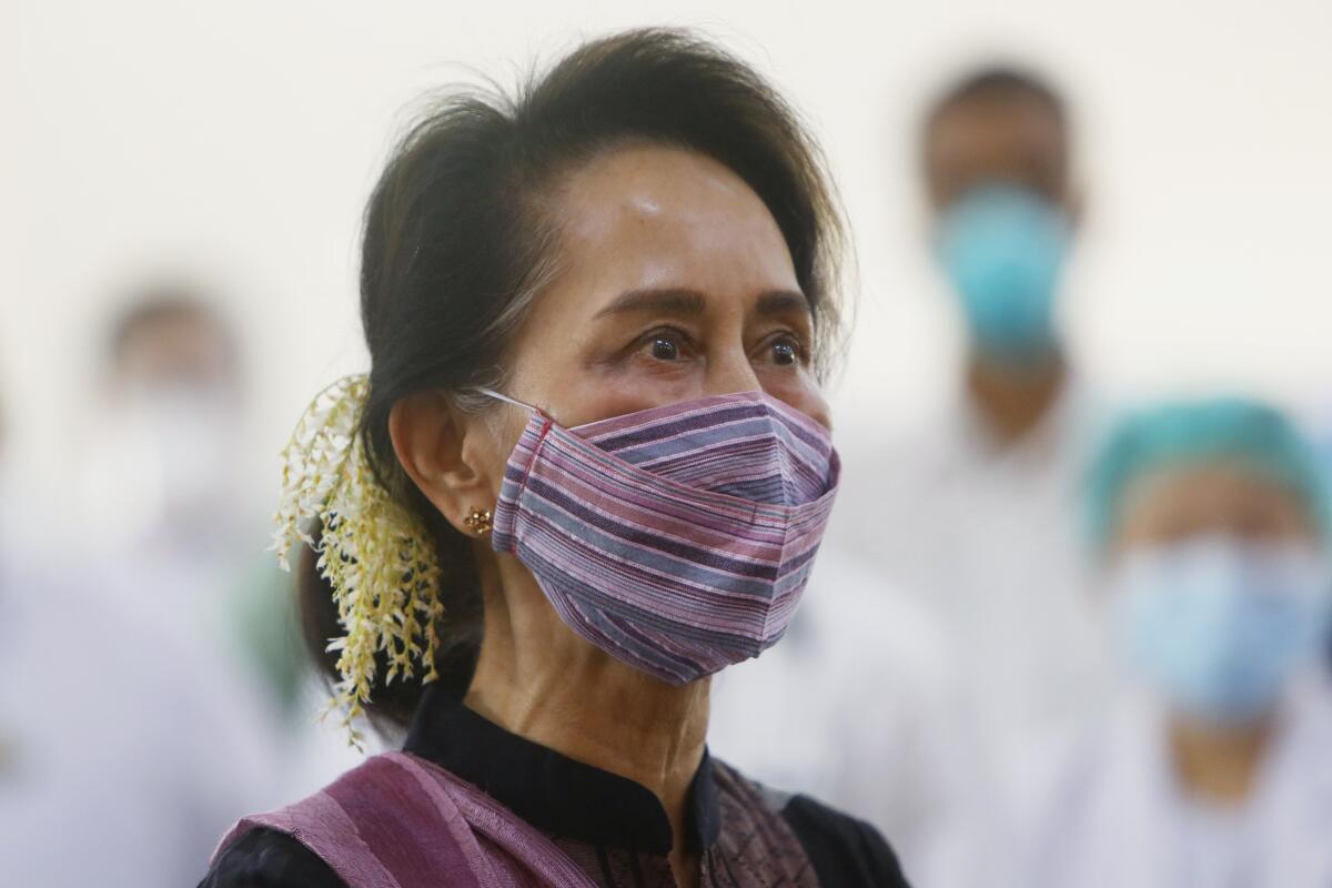FILE - In this Jan. 27, 2021, file photo, Myanmar leader Aung San Suu Kyi watches the vaccination of health workers at a hospital in Naypyitaw, Myanmar. Myanmar’s detained former leader, Suu Kyi, was unable to attend a scheduled court hearing Monday, Sept. 13, 2021, because she felt ill, her lawyers said. She is being tried in the capital Naypyitaw on charges of sedition - defined as spreading information that could cause public alarm or unrest - as well as two counts of flouting COVID-19 pandemic restrictions during the 2020 election campaign. (AP Photo/Aung Shine Oo, File)