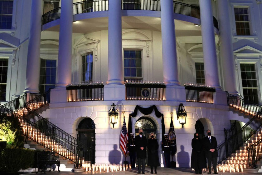 President Biden, First Lady Jill Biden, Vice President Kamala Harris and Second Gentleman Doug Emhoff surrounded by candles.