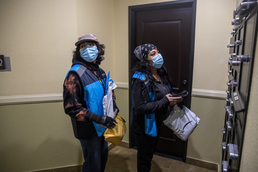 Amid COVID-19 family hardships, high school students work
double duty: jobs and school 2 High school senior Isis Mejia-Duarte and her mom, Marisol Duarte, deliver packages for Amazon on Jan. 27.