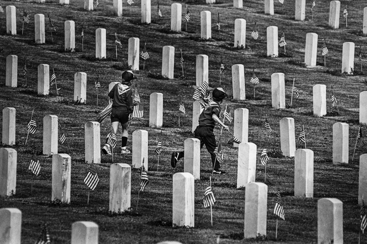 May 23, 1987: Cub Scouts rush to place additional flags for Memorial Day weekend at the Los Angeles National Cemetery in Westwood.