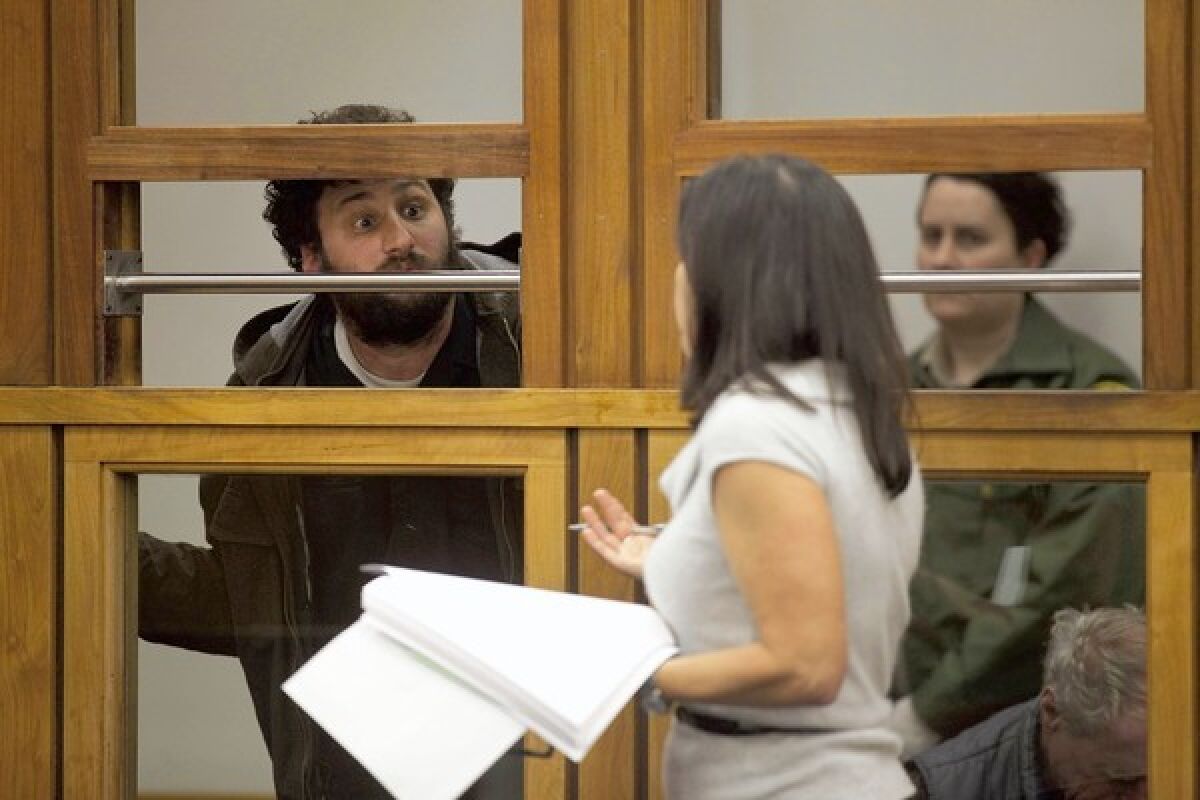John Doe II, who was arrested during the Occupy L.A. raid, attempts to get a last word in with Deputy Public Defender Carrie Miner as she defends his case in Los Angeles' Central Arraignment Court. He was released with no charges.