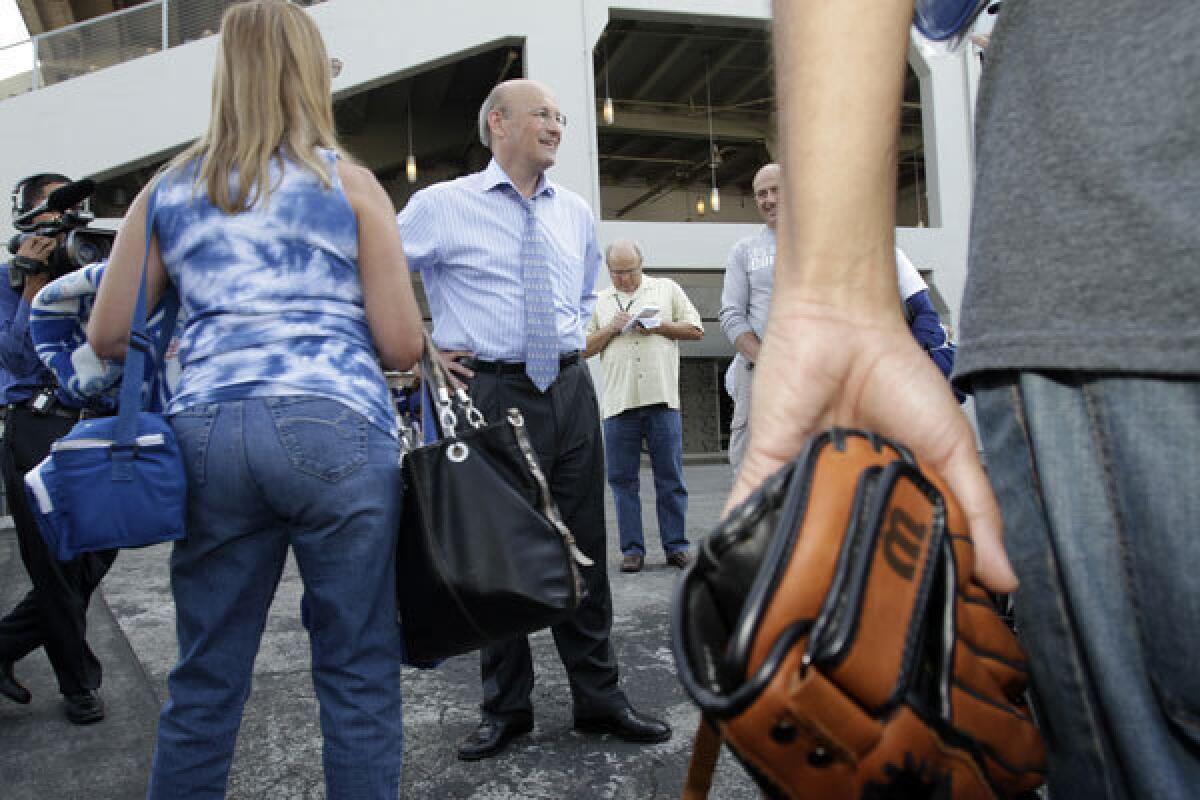 Dodgers' co¿owner Stan Kasten, center, greeting fans at the gate in Dodger Stadium.