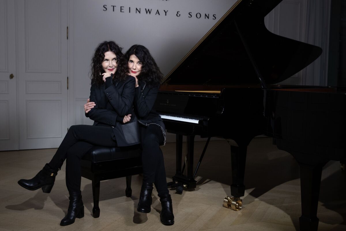 French piano duo sisters Katia (left) and Marielle Labeque pose during a photo shoot in Paris 