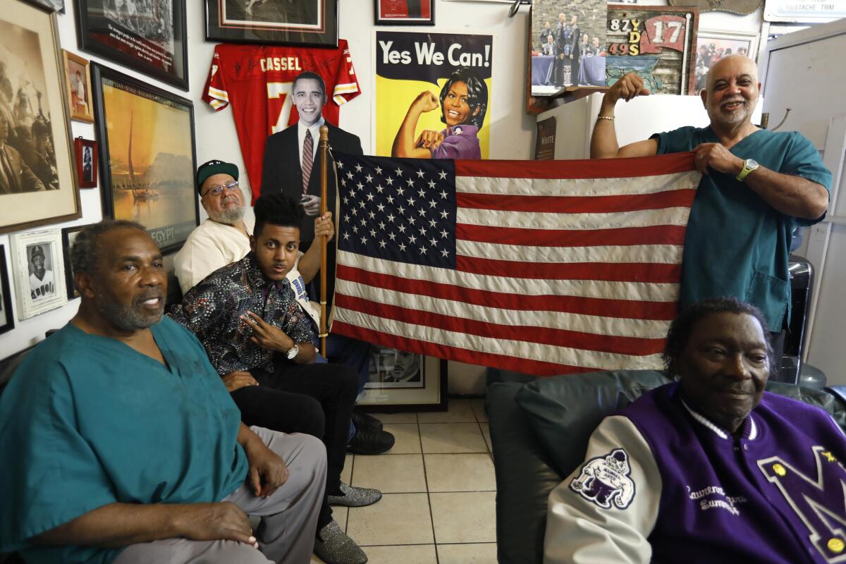 Lawrence Tolliver and customers in his barbershop