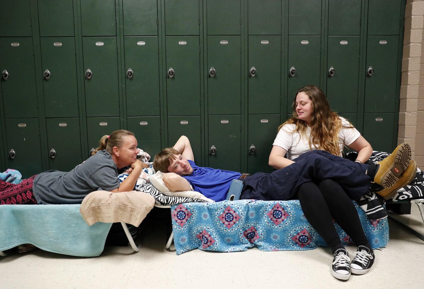 Vickie Grate, left, waits in a shelter with her son Chris, center, and his girlfriend, Sarah, after evacuating from their homes in Conway, S.C., on Wednesday.