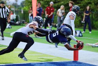 Sierra Canyon receiver Messiah Mingo dives over the goal line against Oaks Christian on Friday night.