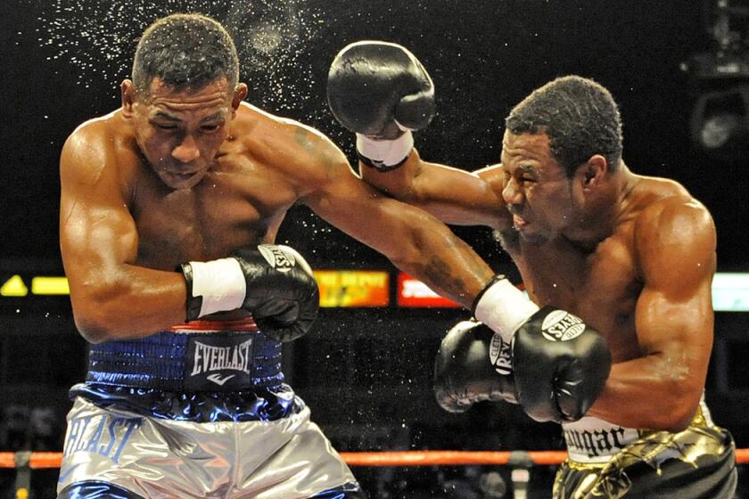 Shane Mosley, right, knocks the sweat out of Ricardo Mayorga at Home Depot Center in Carson on Sept. 27, 2008.