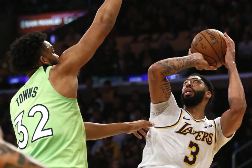 LOS ANGELES, CALIFORNIA - DECEMBER 08: Anthony Davis #3 of the Los Angeles Lakers shoots the ball as Karl-Anthony Towns #32 of the Minnesota Timberwolves defends during the second half at Staples Center on December 08, 2019 in Los Angeles, California. NOTE TO USER: User expressly acknowledges and agrees that, by downloading and or using this photograph, User is consenting to the terms and conditions of the Getty Images License Agreement. (Photo by Katharine Lotze/Getty Images)