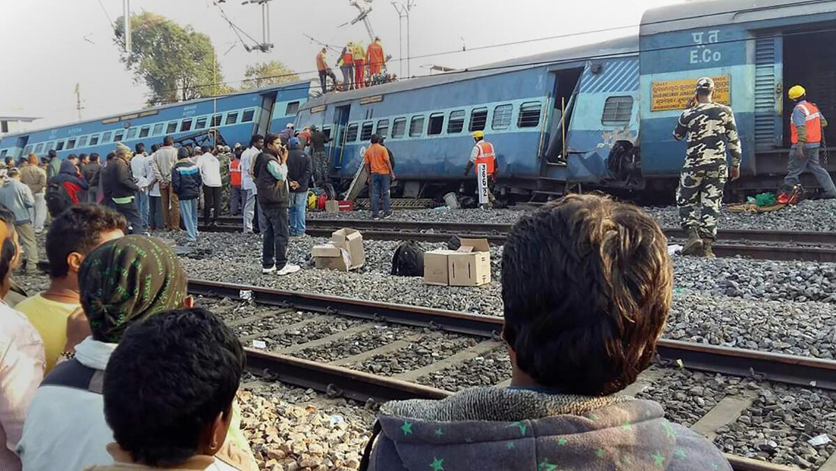 Rescue workers look for derailment survivors near the Kuneru railway station in Andhra Pradesh state.