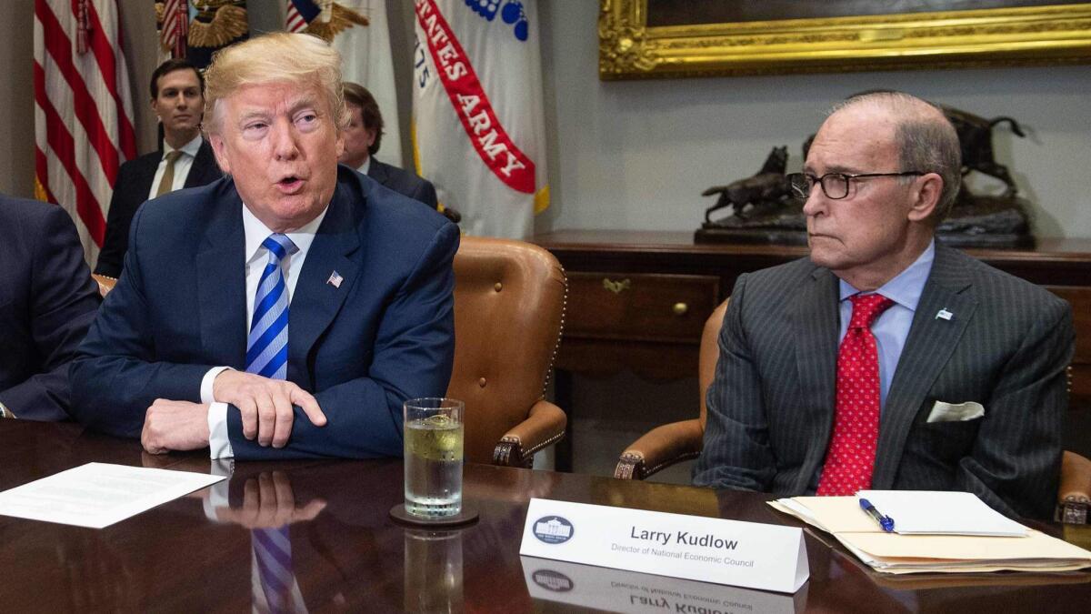 President Trump, with his economic advisor, Larry Kudlow, speaks at a White House meeting on May 11.