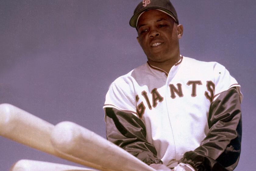 Willie Mays, San Francisco Giants outfielder, poses with three bats in 1968. (AP Photo)