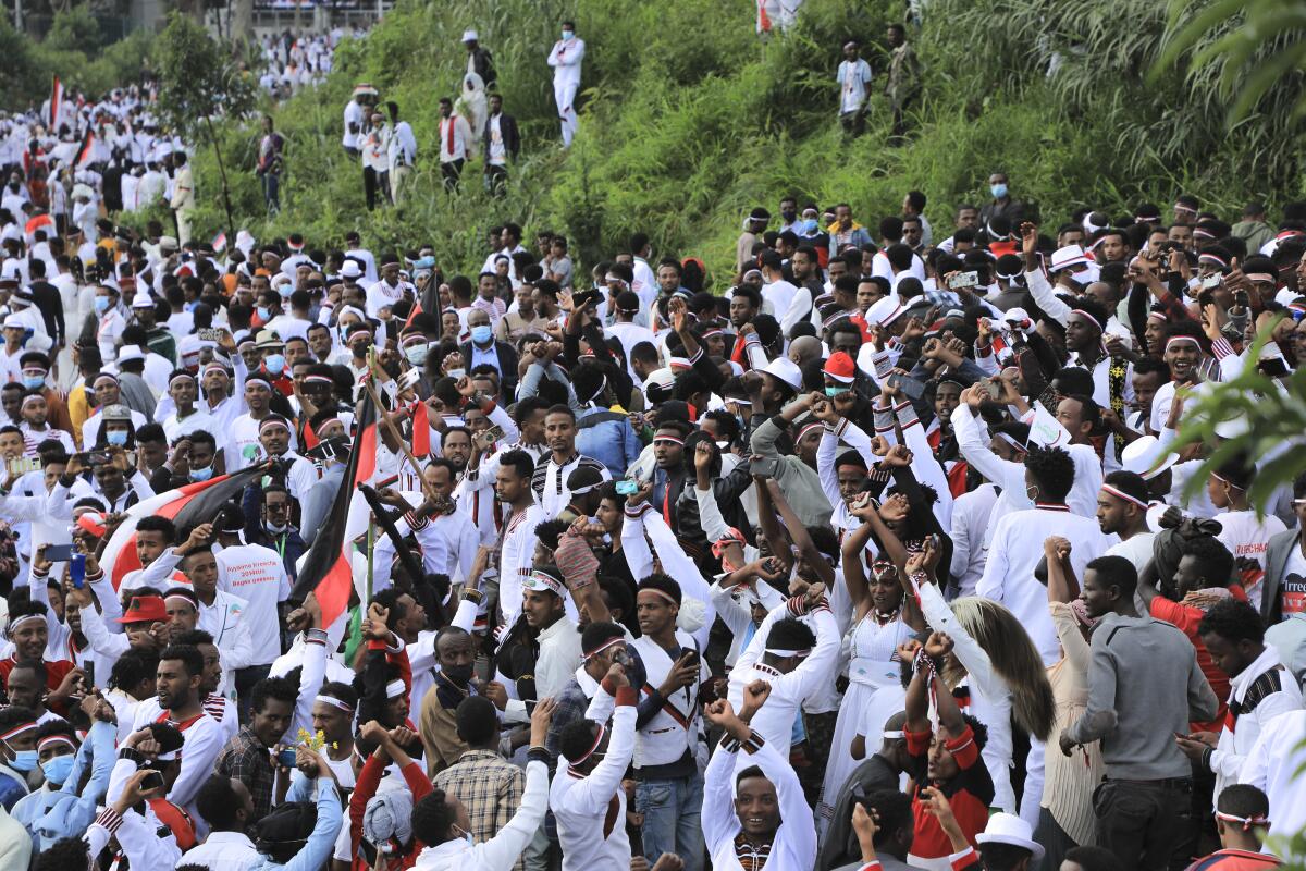 Oromos protest against the government and call for the release of prominent opposition figure Jawar Mohammed and others, during the annual Irreecha festival in the capital Addis Ababa, Ethiopia, Saturday, Oct. 2, 2021. Ethiopia's largest ethnic group, the Oromo, on Saturday celebrated the annual Thanksgiving festival of Irreecha, marking the end of winter where people thank God for the blessings of the past year and wish prosperity for the coming year. (AP Photo)