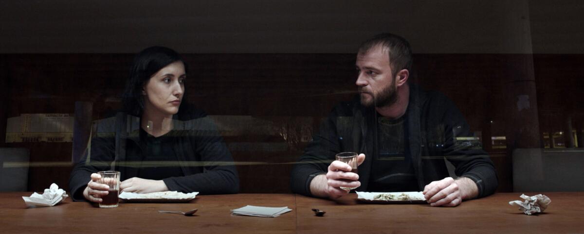Liudmyla Bileka and Andriy Rymaruk have a drink in the movie "Atlantis."