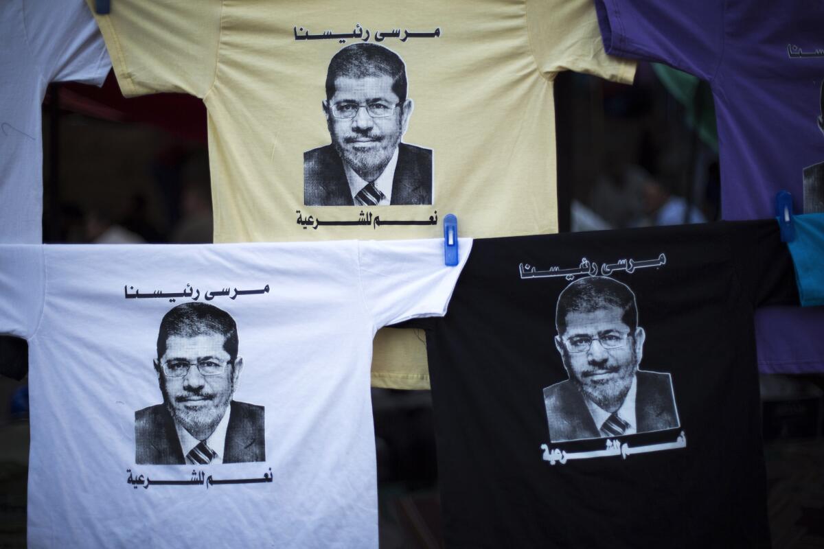 T-shirts with the face of Egypt's ousted President Mohamed Morsi are displayed for sale in the Nasr City area of Cairo, where pro-Morsi protesters have been holding a monthlong sit-in.
