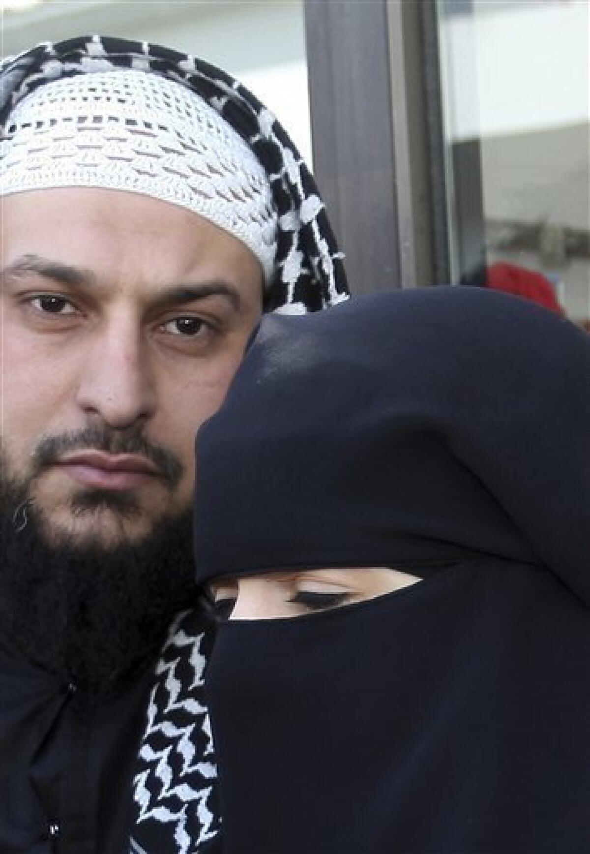 FILE - In this April 23, 2010 picture Lies Hebbadj, left, and his wife Sandrine Mouleres , speak to reporters in Nantes, western France. A French court on Monday Dec. 12, 2010 annulled a fine given to a woman driver wearing an Islamic face veil before France's nationwide ban on the garments goes into effect. Traffic police in the western city of Nantes had fined 31-year-old Sandrine Mouleres in April, saying she did not have a clear field of vision. The fine was just euros22, ($29) but drew widespread attention amid nationwide debate over the place of Islamic veils in today's France. (AP Photo/David Vincent, File)