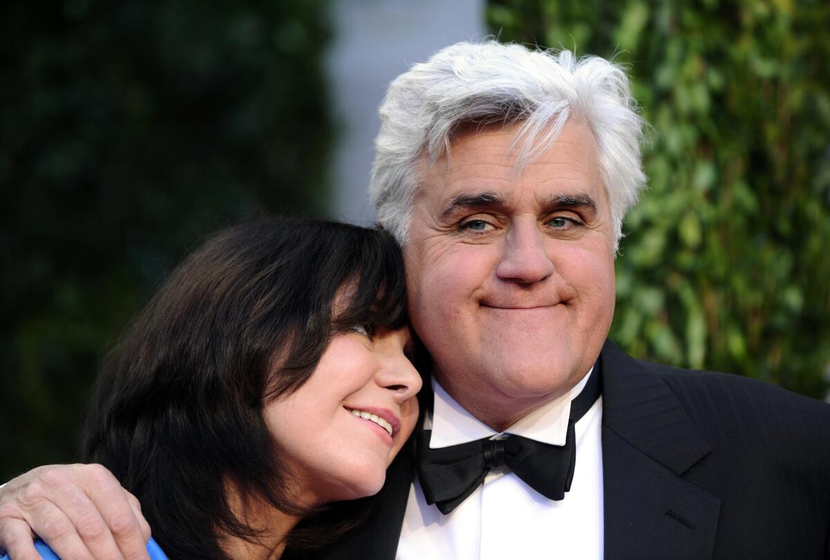 Jay Leno, right, in a tuxedo smiles while his wife Mavis leans on his shoulder