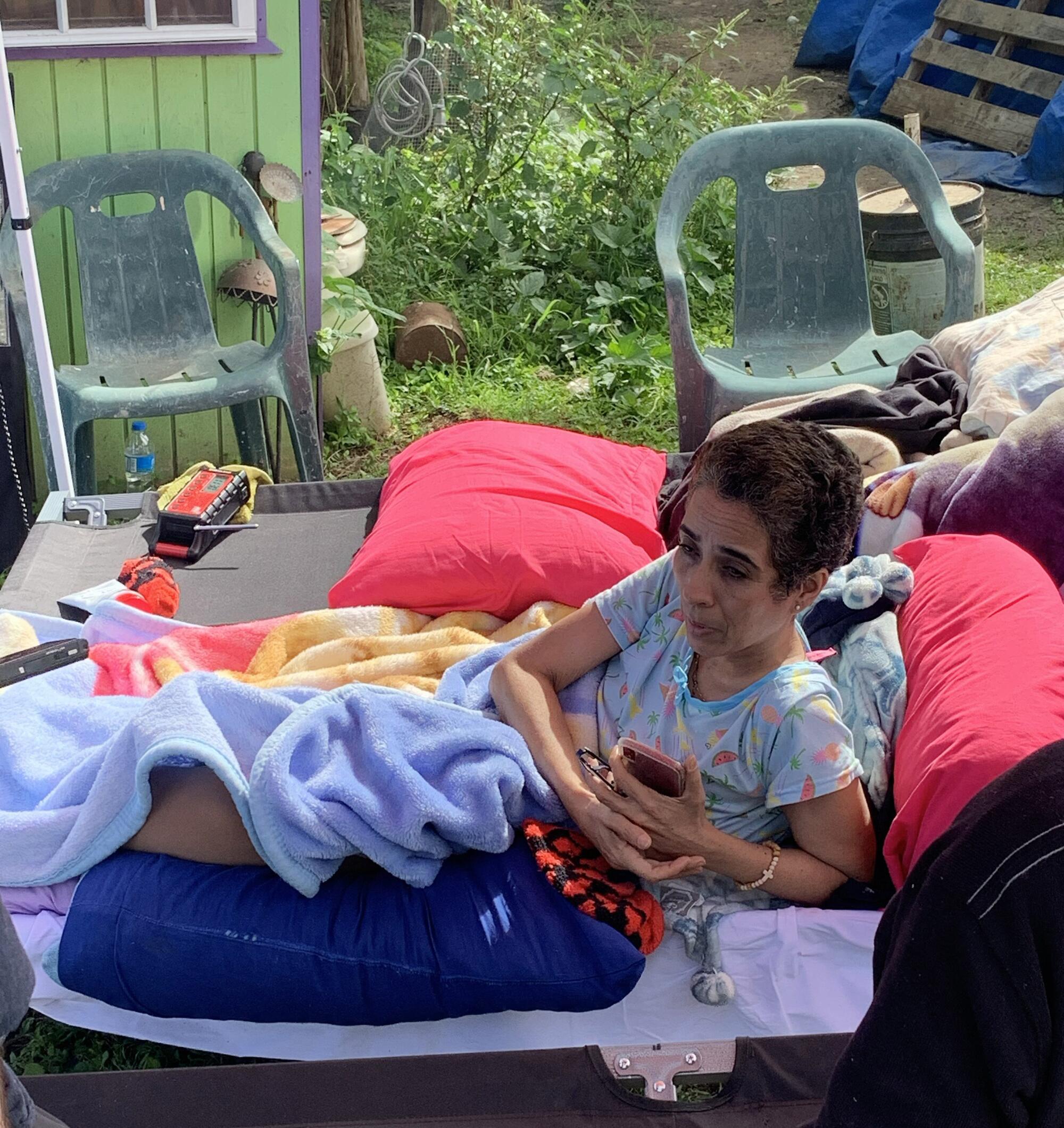 Marianela González Cintrón, who is bedridden with cancer, has a cot set up an area outside her home in Guayanilla, Puerto Rico, following the earthquakes.