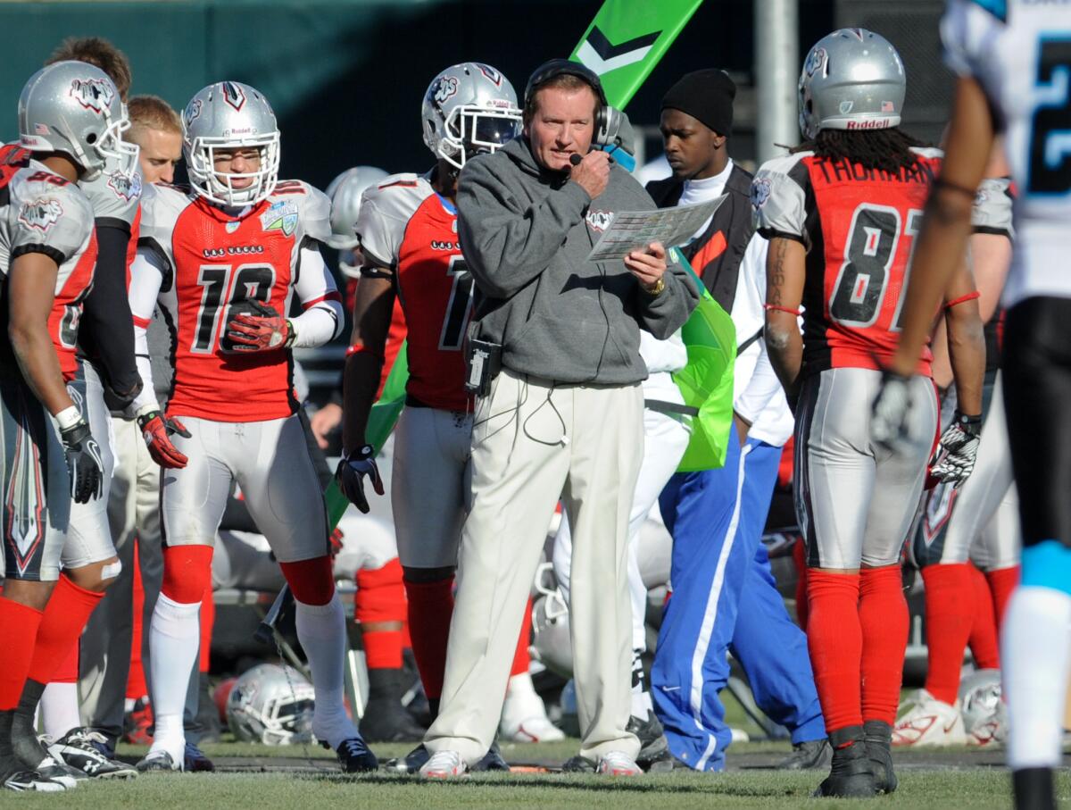 Las Vegas head coach Jim Fassel, center, looks on from the sideline.