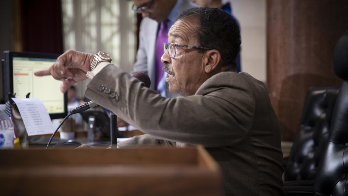 Los Angeles City Council president Herb J. Wesson, Jr., notifies speakers their time is up as protesters speak before the council votes to crack down on people who repeatedly disrupt their meetings at Los Angeles City Hall.