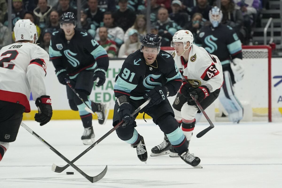 Seattle Kraken right wing Daniel Sprong (91) skates in front of Ottawa Senators left wing Parker Kelly (45) during the second period of an NHL hockey game, Monday, April 18, 2022, in Seattle. (AP Photo/Ted S. Warren)